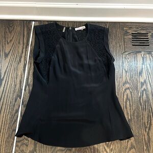 Rebecca Taylor black silk top w/lace detailing at the shoulders. Zips halfway up